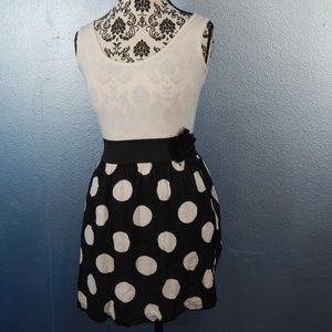 Polka dot dress with black flower pin